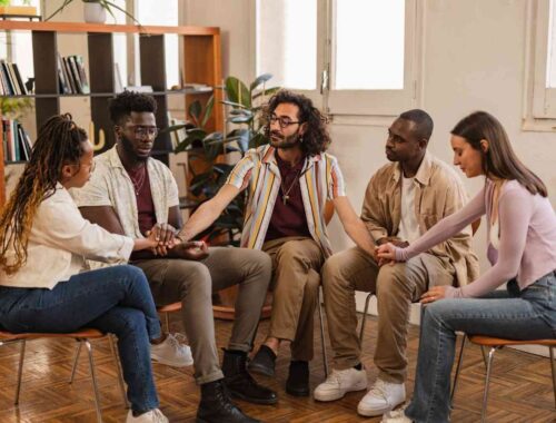 group-sitting-in-circle-holding-hands-indoors-2026-03-19-02-14-46-utc (1)