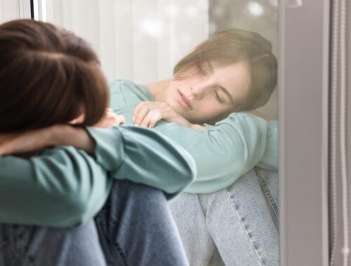 pensive-woman-leaning-on-window-in-thoughtful-mome-2026-03-25-07-00-21-utc (1)