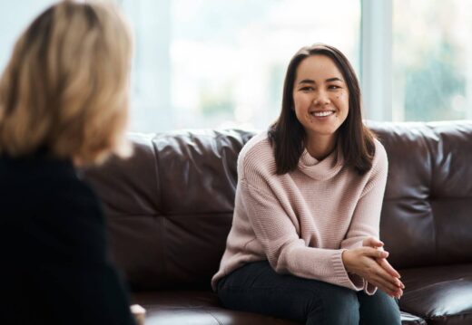 woman-smiling-during-meeting-on-brown-leather-couc-2026-03-25-01-47-27-utc (1)