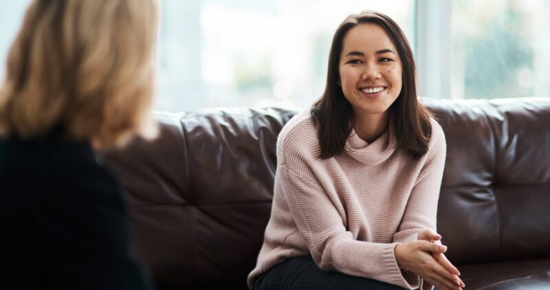 woman-smiling-during-meeting-on-brown-leather-couc-2026-03-25-01-47-27-utc (1)